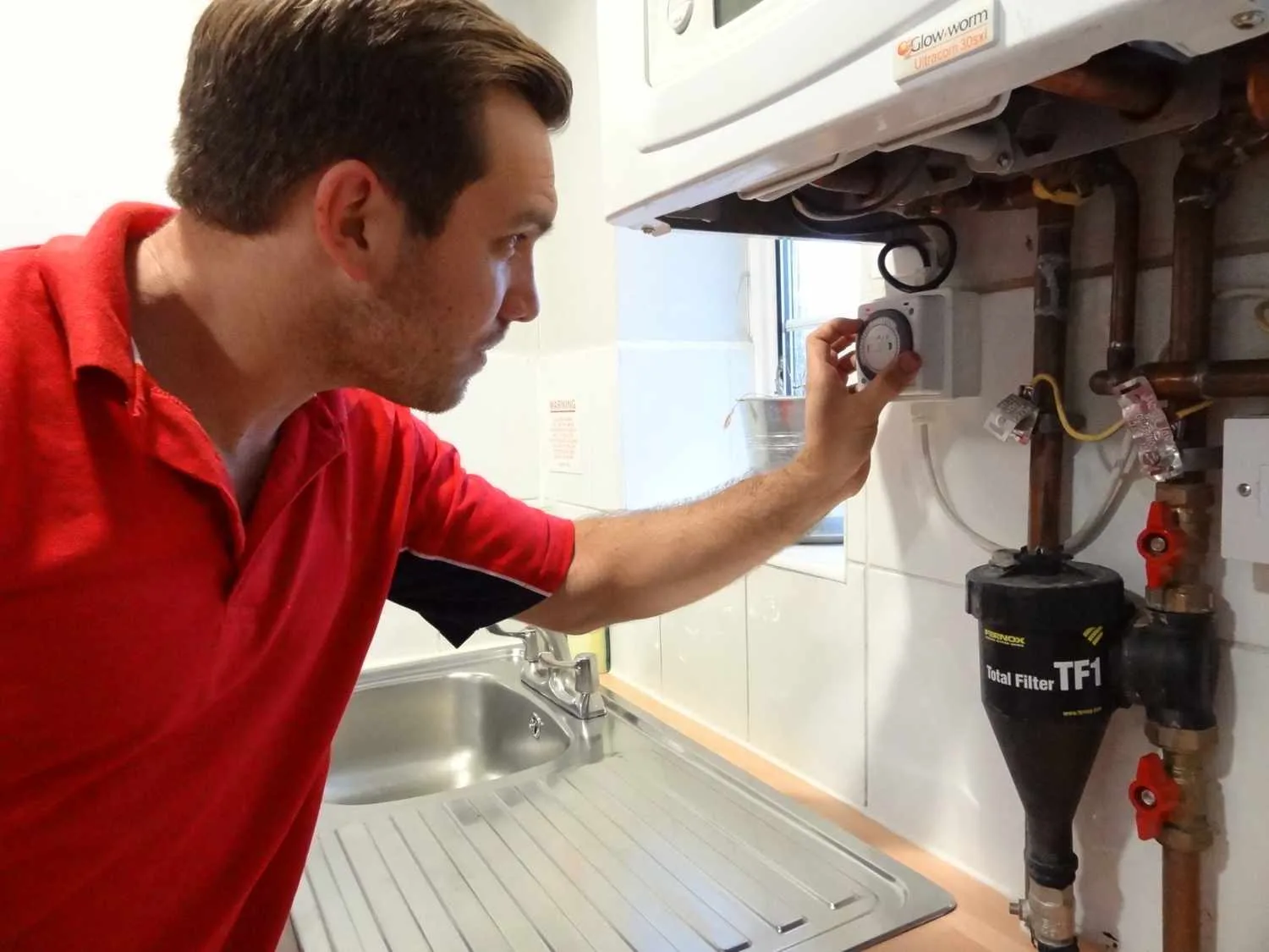 Richmond Plumbers 247 boiler repair engineer working on a boiler in Richmond